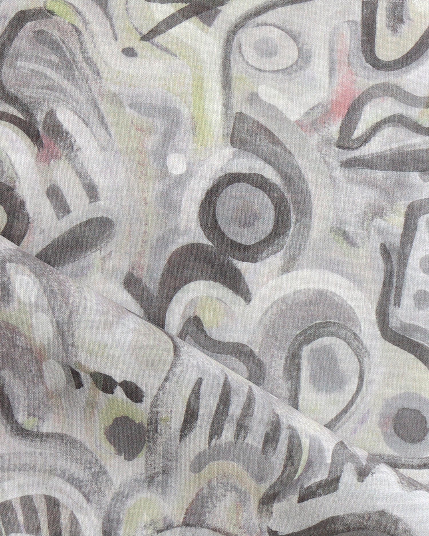 Draped fabric in abstract brushstroke design in shades of grey, tan and blush accents. 