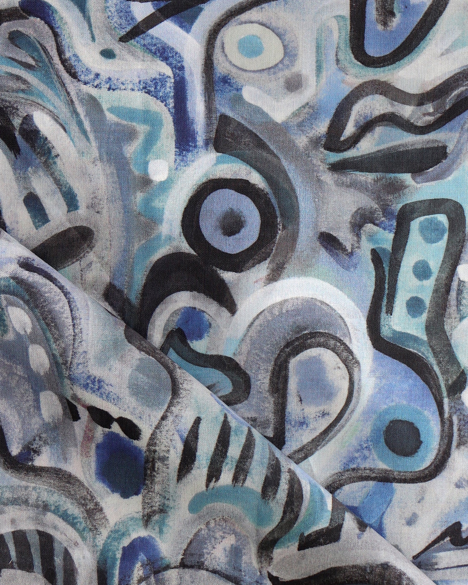 Draped fabric in abstract brushstroke design in shades of blue, aqua and black accents. 