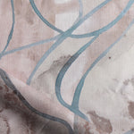 Draped fabric in abstract floral bushstroke design in warm mauve with teal. 