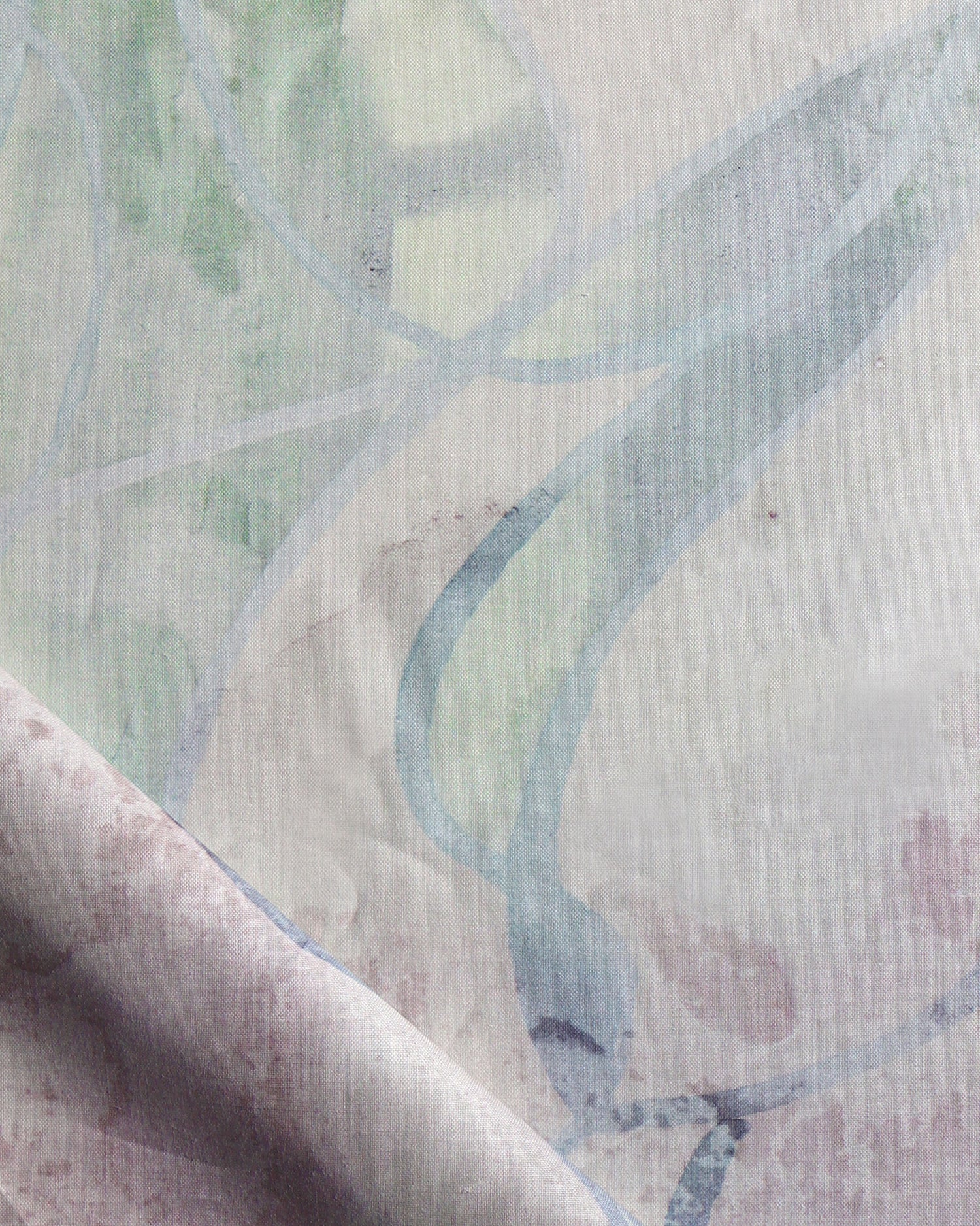 Draped fabric in abstract floral bushstroke design in sage green, lilac and blue. 