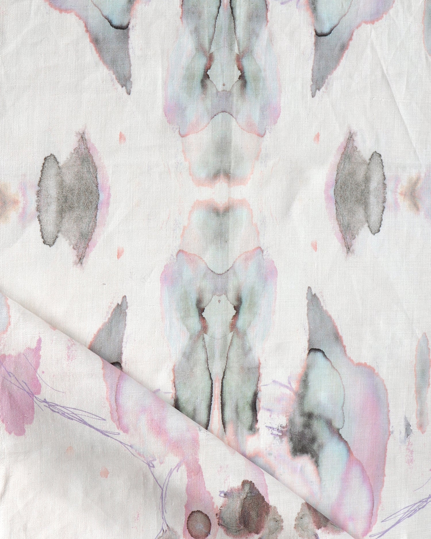 Detail of draped fabric in a watercolor paint blotch print in shades of gray and pink on a white field.