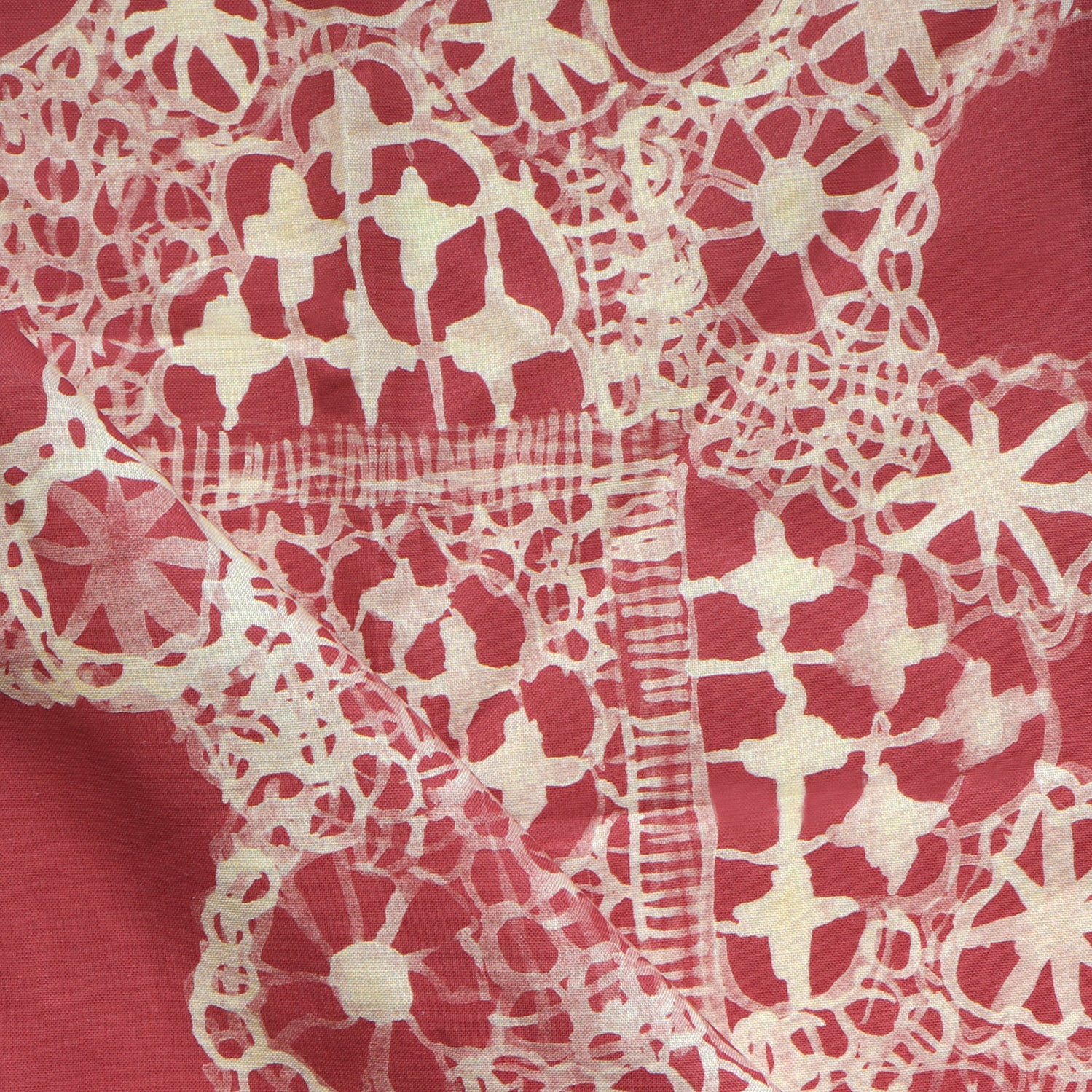 White lace pattern on a red fabric background
