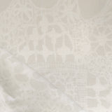 Close-up of a watercolor lace design in soft beige. 