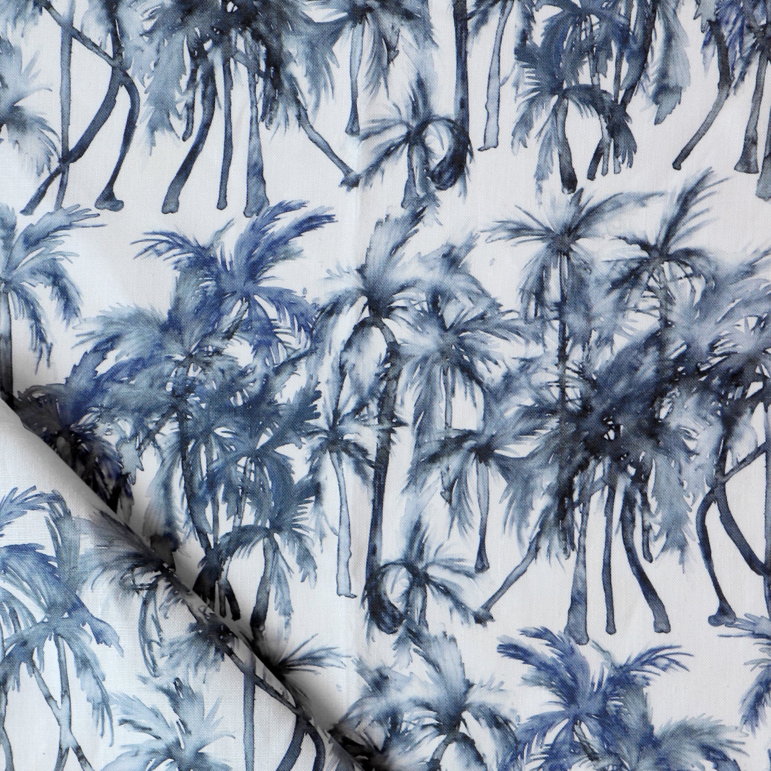 Detail of draped fabric in a painterly palm tree stripe print in shades of navy and gray on a white field.