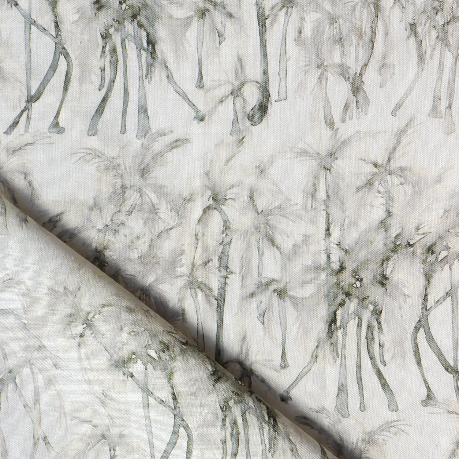 Detail of draped fabric in a painterly palm tree stripe print in shades of cream and gray on a white field.