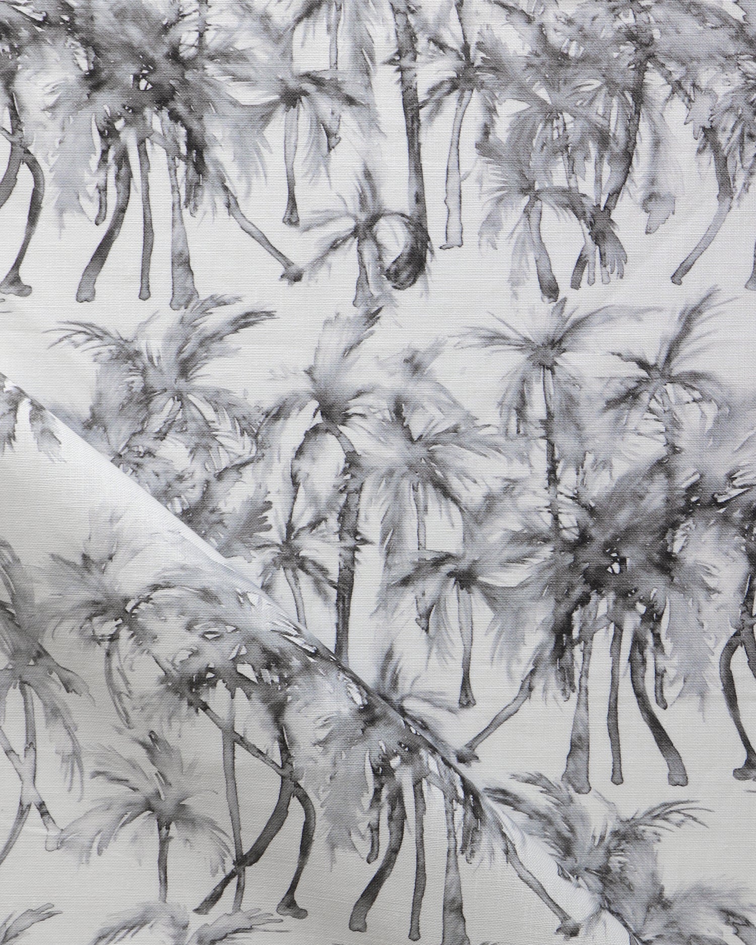 Detail of draped fabric in a painterly palm tree stripe print in shades of gray on a white field.