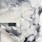 Detail of draped fabric in a watercolor painterly print in shades of gray and white.