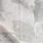 Detail of draped fabric in a watercolor painterly print in shades of gray and cream.