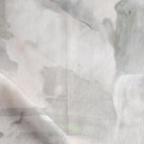 Detail of draped fabric in a watercolor painterly print in shades of gray and cream.
