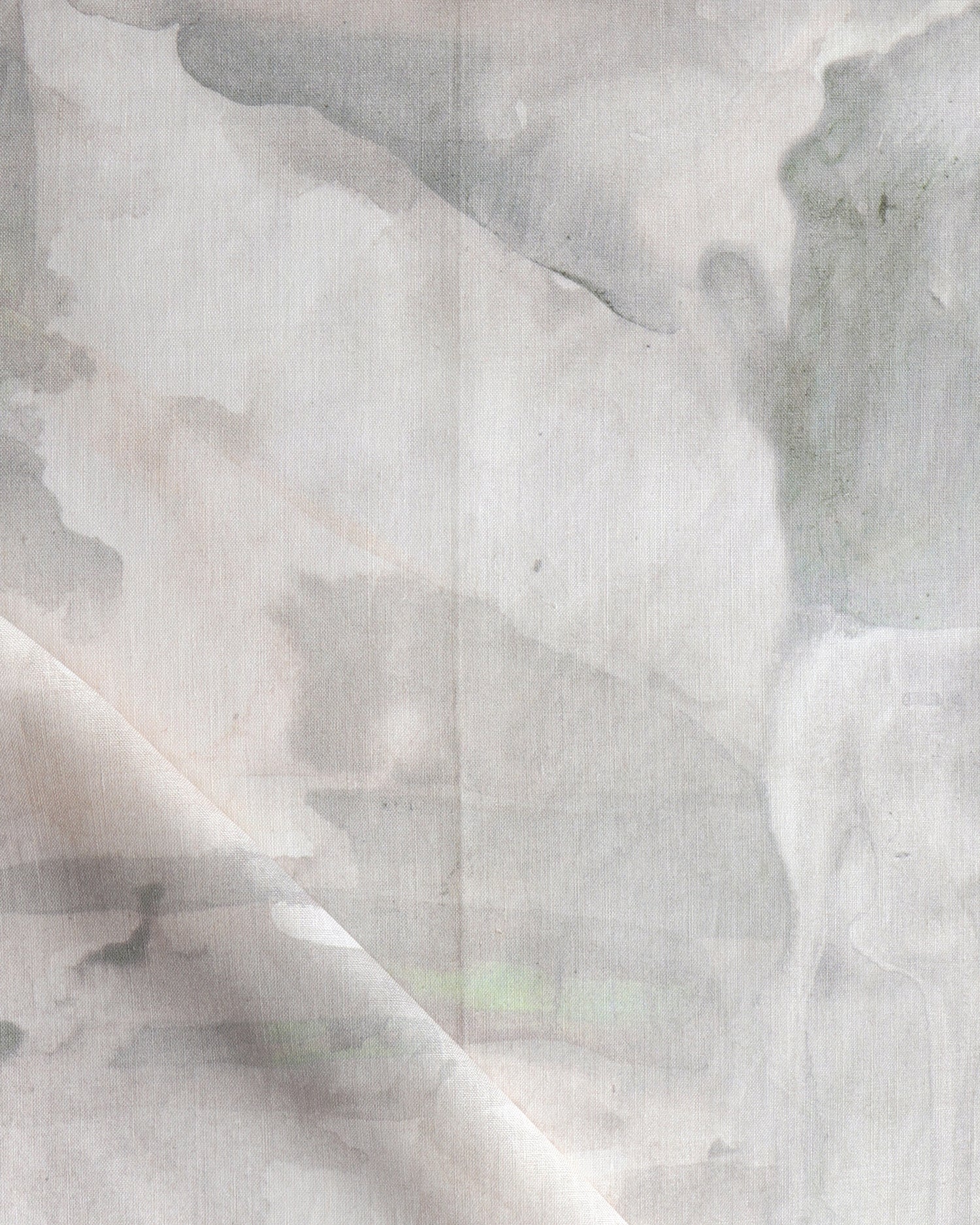 Detail of draped fabric in a watercolor painterly print in shades of gray and cream.