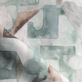 Draped fabric in a geometric puzzle piece watercolor pattern in sage green, grey and brown. 