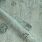 Draped fabric in an watercolor oceanic fish pattern in sage green. 