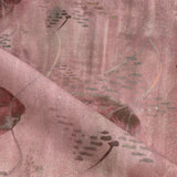 Draped fabric in an watercolor oceanic fish pattern in warm clay red. 