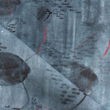 Draped fabric in an watercolor oceanic fish pattern in navy blue. 