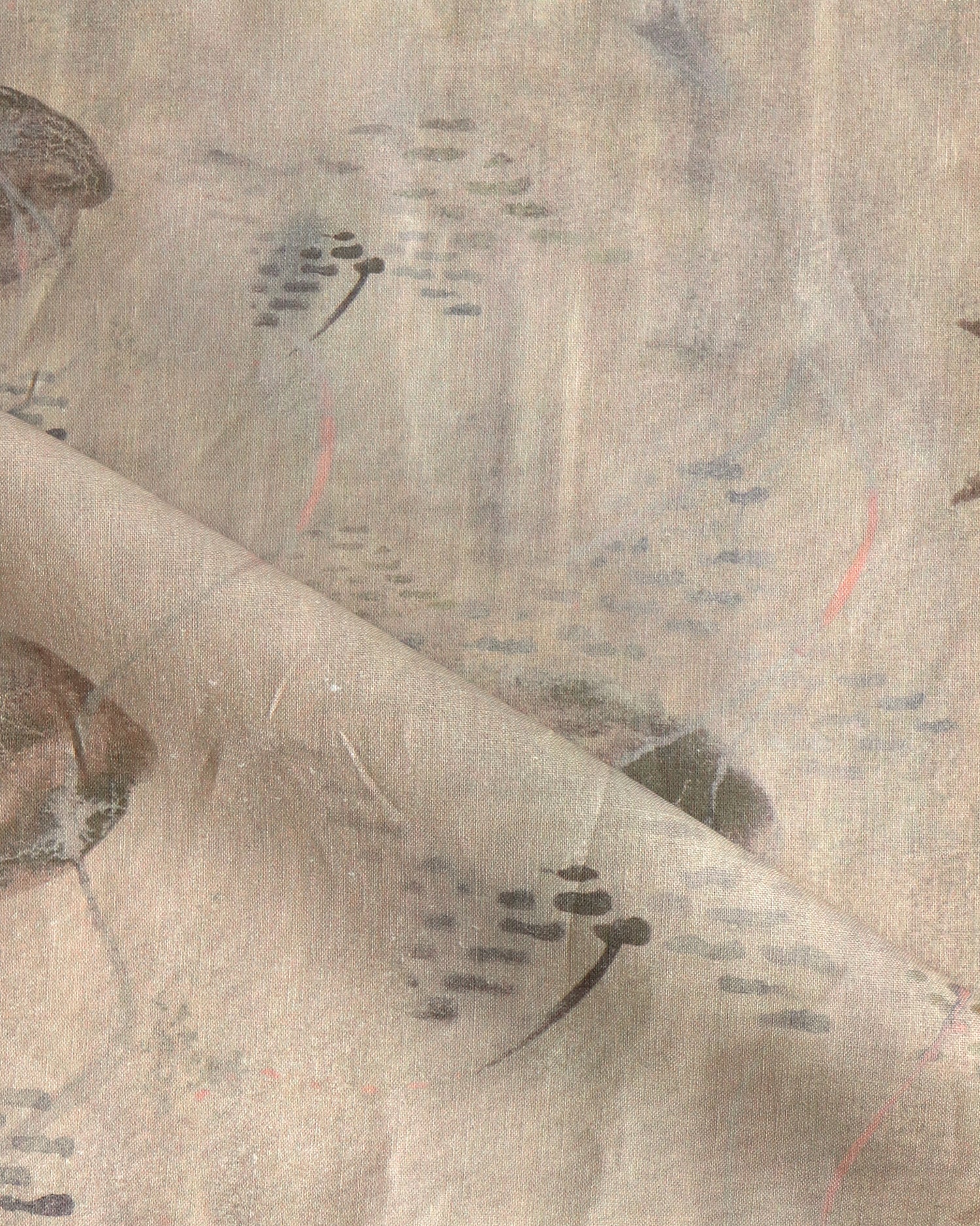 Draped fabric in an watercolor oceanic fish pattern in warm tan. 