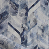 Detail of draped fabric in a painterly herringbone print in shades of blue and gray.