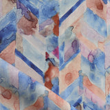 Detail of draped fabric in a painterly herringbone print in shades of blue, pink and orange.