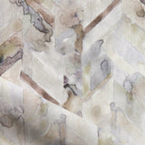 Detail of draped fabric in a painterly herringbone print in shades of gray, tan and cream.