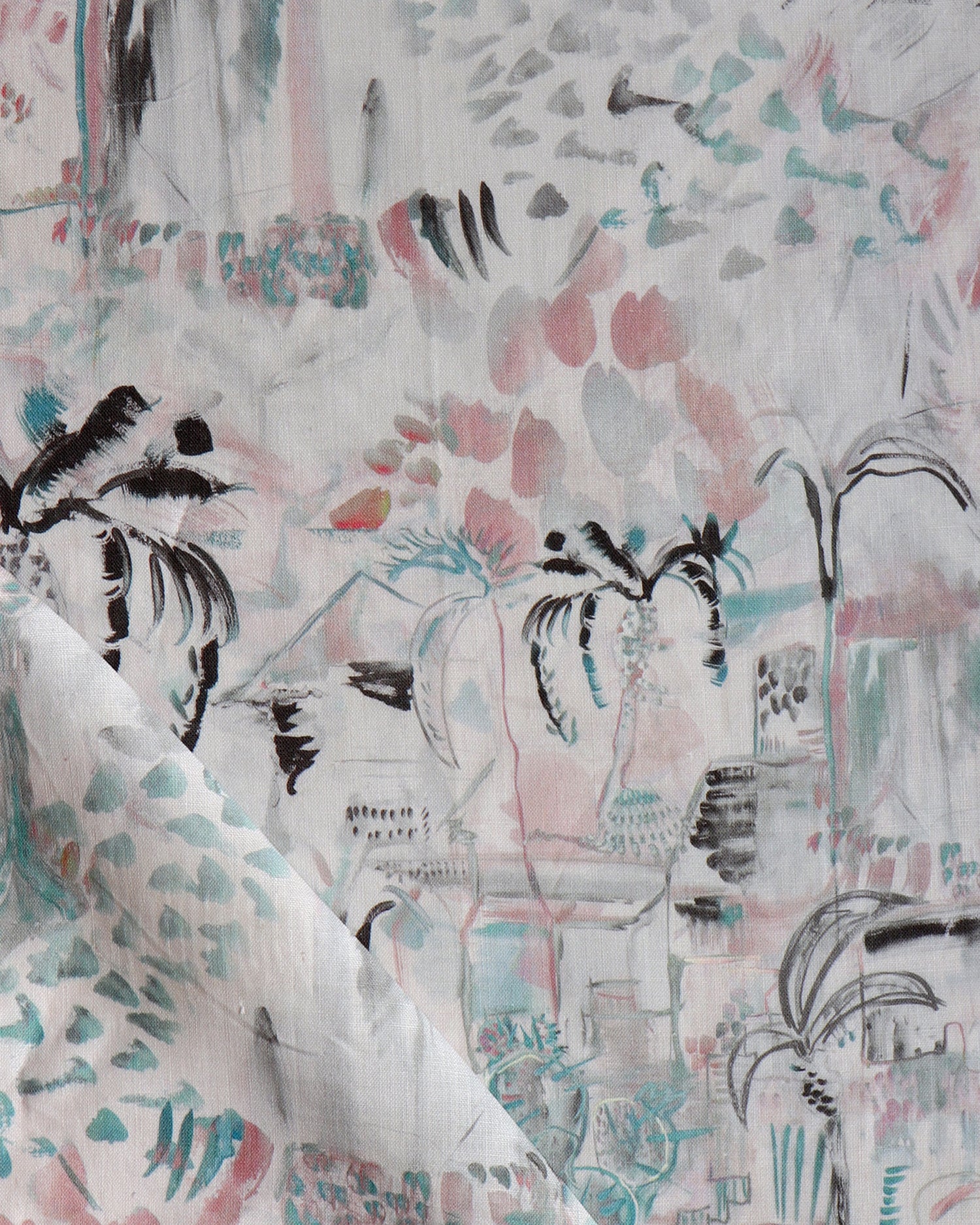 Detail of draped fabric in a painterly tree print in shades of gray, pink and turquoise.