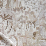 Detail of draped fabric in a painterly tree print in shades of gray, tan and cream.