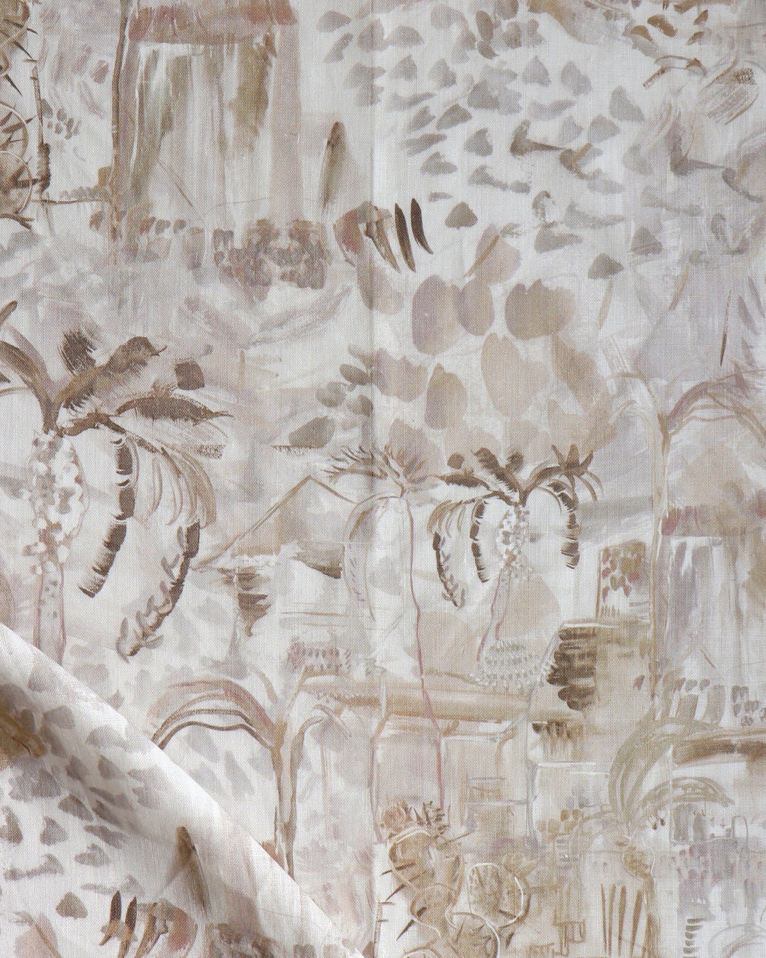 Detail of draped fabric in a painterly tree print in shades of gray, tan and cream.