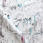 Detail of draped fabric in a painterly tree print in shades of gray, white, turquoise and pink.