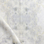 Detail of draped fabric in a watercolor textural print in shades of cream, gray and tan.