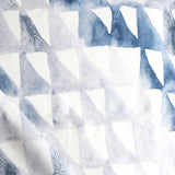 Detail of draped fabric in a painterly check pattern in shades of blue, gray and white.