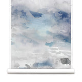 Wallpaper roll of an ethereal watercolor mural in shades of blue and grey. 