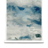 Wallpaper roll of an ethereal watercolor mural in shades teal, blue and soft grey. 