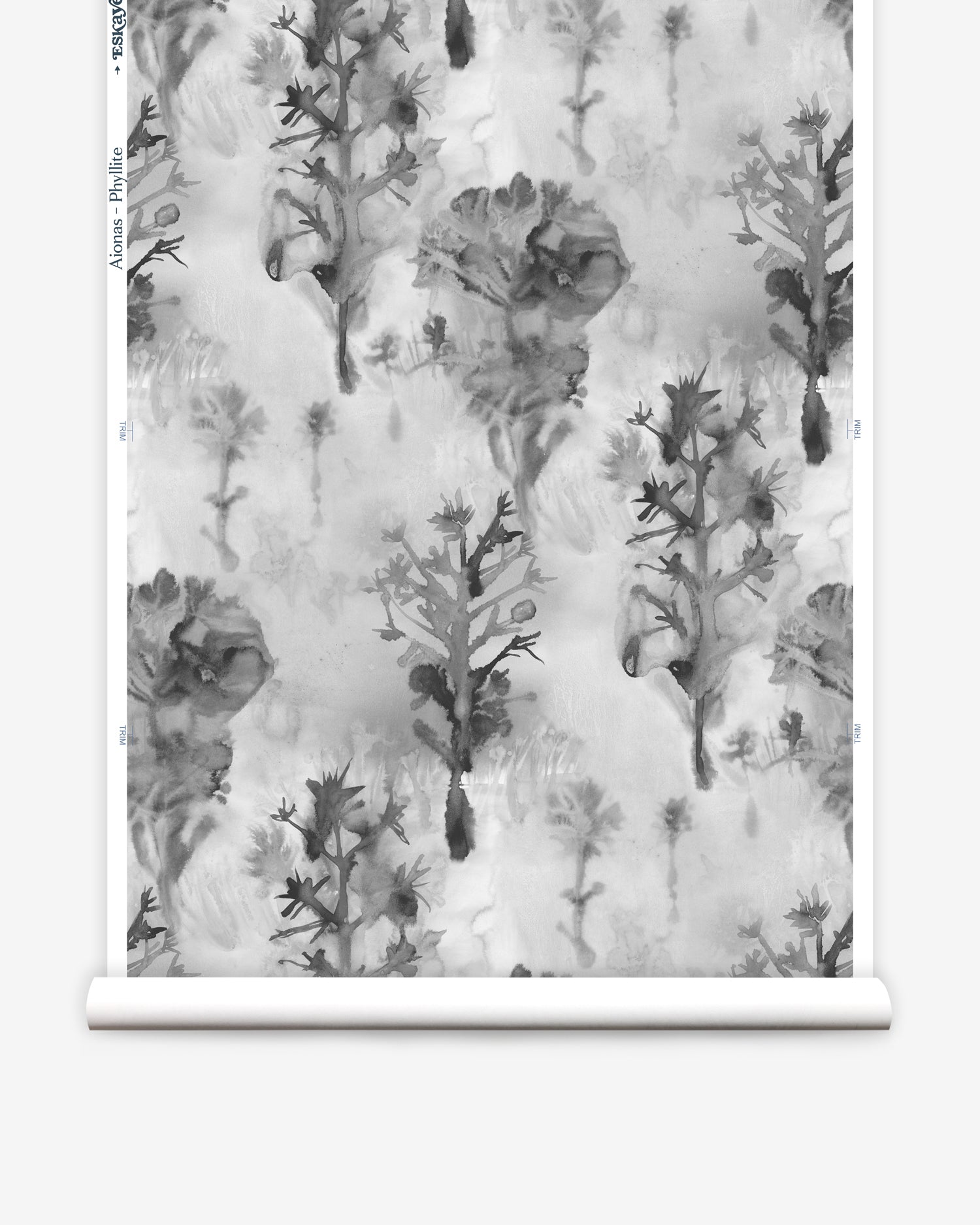 Wallpaper roll in a watercolor tree print in shades of gray and black on a white field.