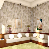 Retro living room scene with built in white couche against a wallpaper in an elegant watercolor pattner in purple, tan and teal. 