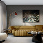 Sophisticated living room scene with sculptural tan couch, black coffee table and floor lamp against a scalloped wallpaper. 