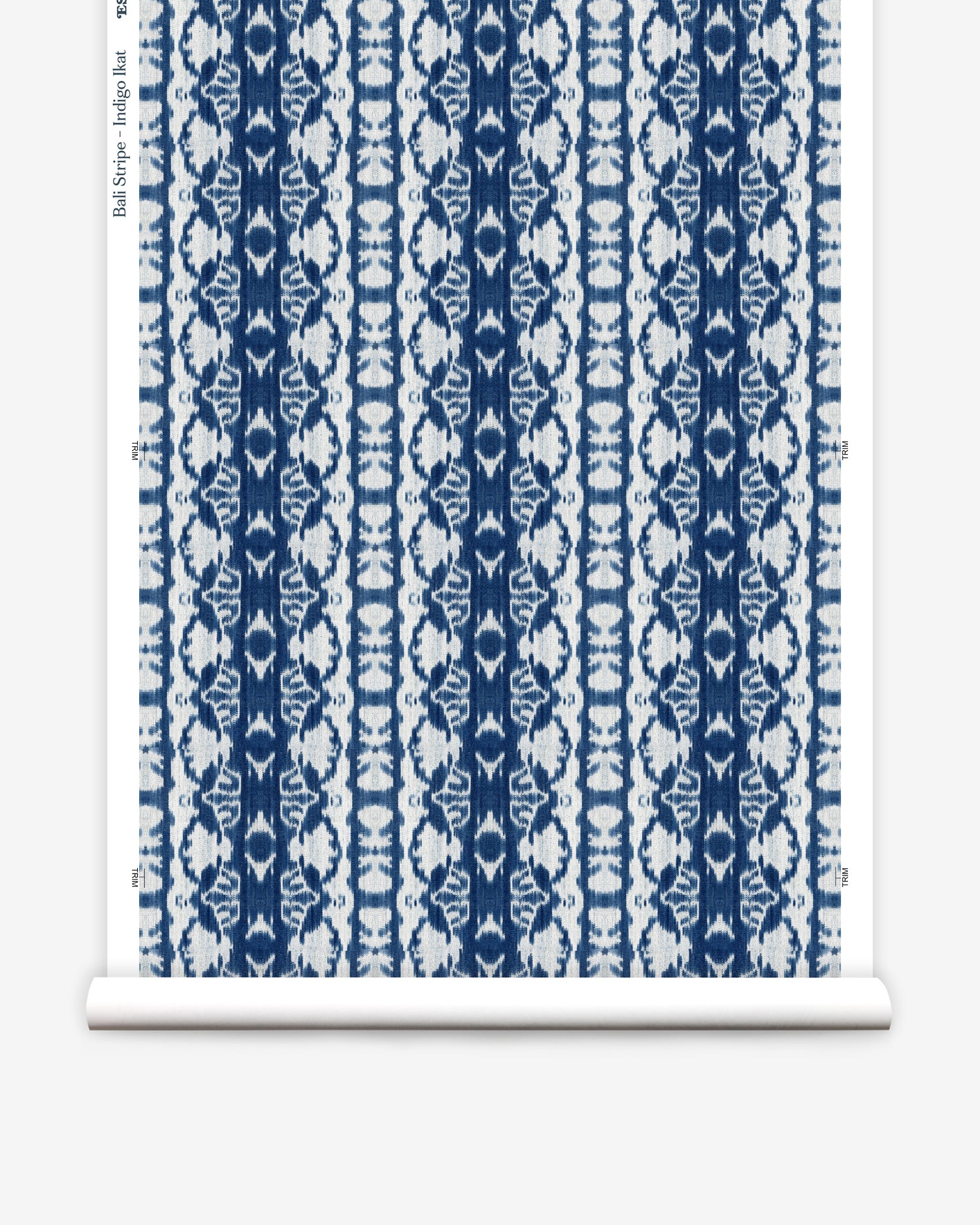 Wallpaper roll in a watercolor ikat stripe print in shades of white and blue on a gray field.