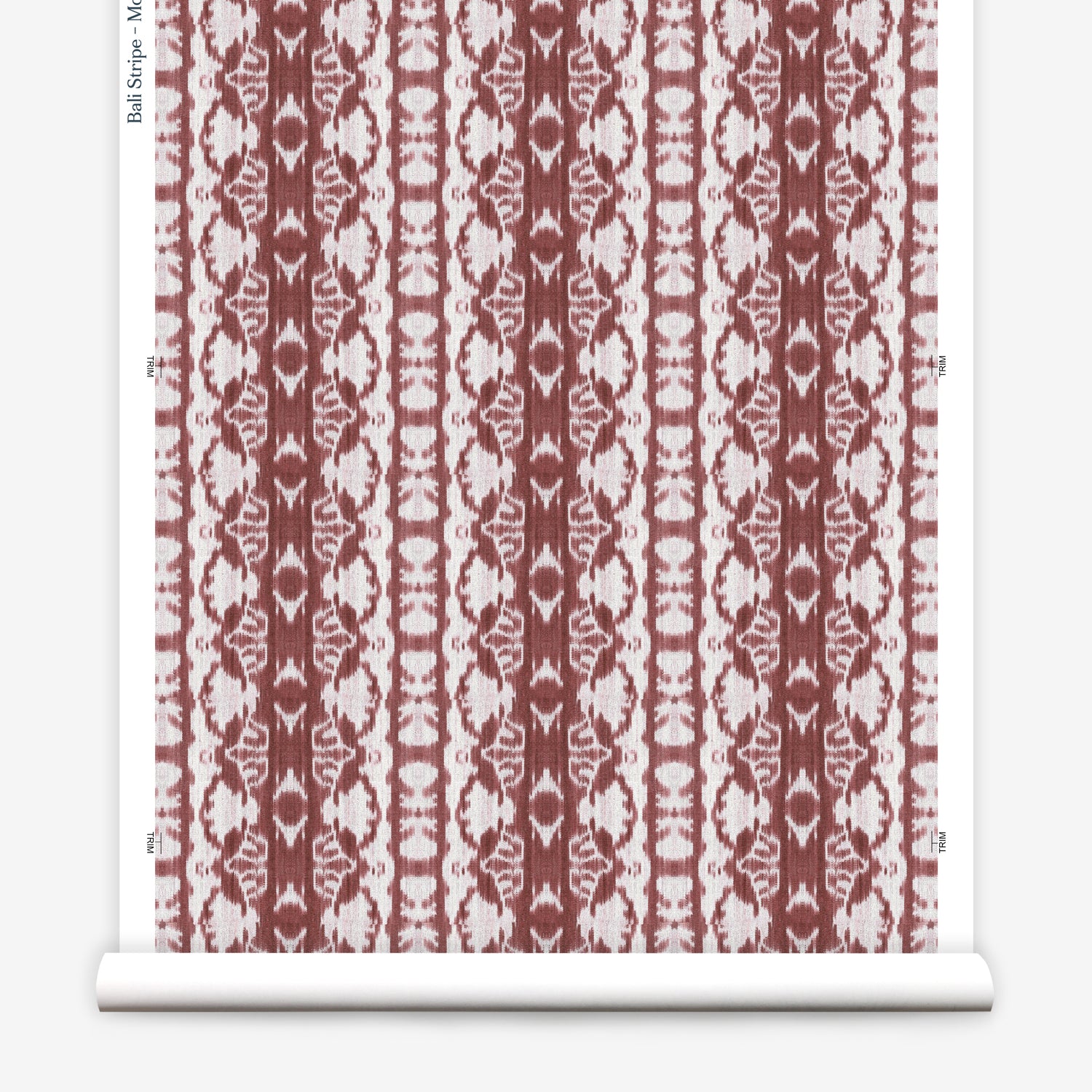 Wallpaper roll in a watercolor ikat stripe print in shades of white on a red field.