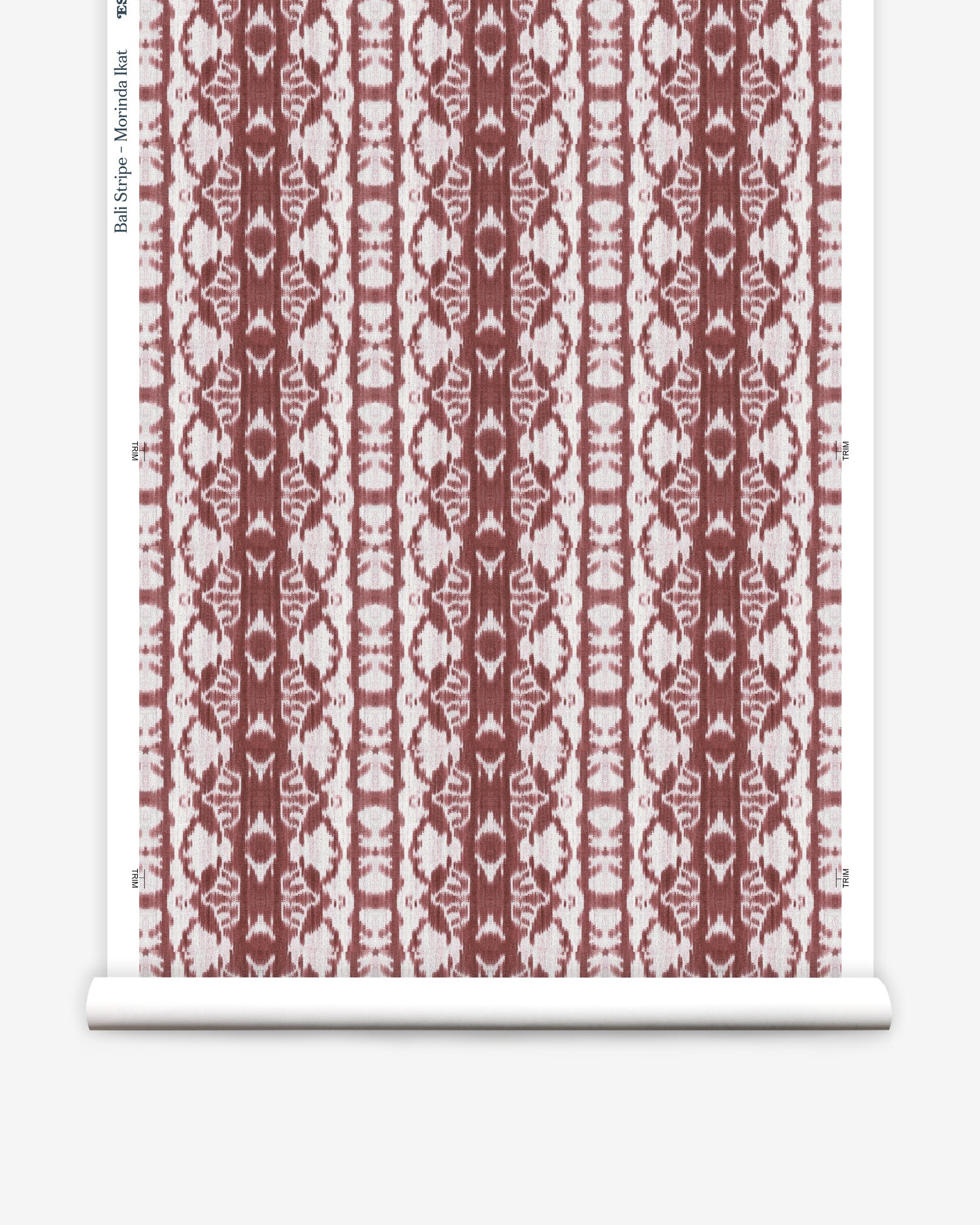 Wallpaper roll in a watercolor ikat stripe print in shades of white on a red field.