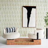Wallpaper install a painterly stripe print in olive on a white field with white accent chairs, abstract painting, and a branch vase.
