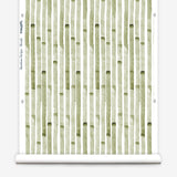 Wallpaper roll in a painterly stripe print in olive on a white field.