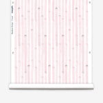 Wallpaper roll  in a painterly stripe print in light pink on a white field.