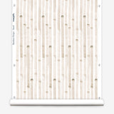 Wallpaper roll in a painterly stripe print in tan on a white field.