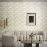Modernist living room with beige leather couch, steel table and framed art against textural taupe watercolor wallpaper. 
