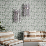 Vintage living room with striped couch and glass sconces against textural watercolor in muted teal. 