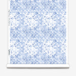 Wallpaper roll with blue and white watercolor floral pattern on a white background.