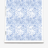 Wallpaper roll with blue and white watercolor floral pattern on a white background.