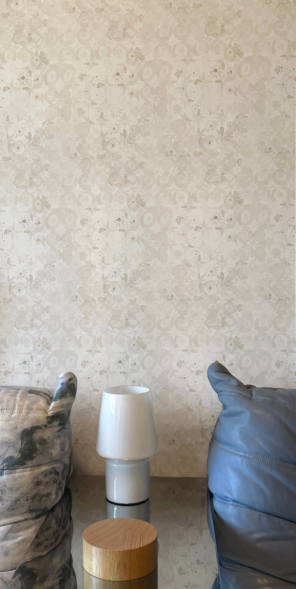 Small white lamp on a surface with a textured wall in the background