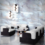 Living room scene against  against cool blue watercolor mural wallpaper. 