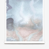 Mural wallpaper roll in an abstract textural watercolor design in blue with taupe. 