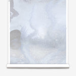 Mural wallpaper roll in an abstract textural watercolor design in pale grey blue. 