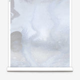 Mural wallpaper roll in an abstract textural watercolor design in pale grey blue. 