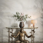 Playful monkey console table against warm sand watercolor mural. 